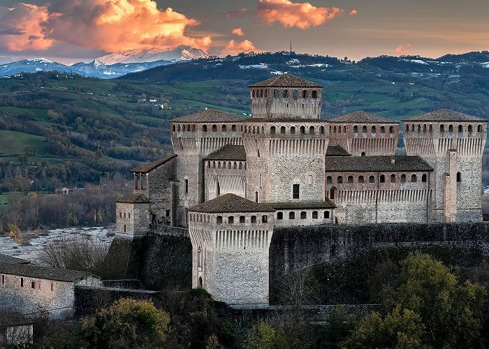 Castle of Torrechiara Torrechiara castle at twilight and the Cusna mount, Langhirano ... photo