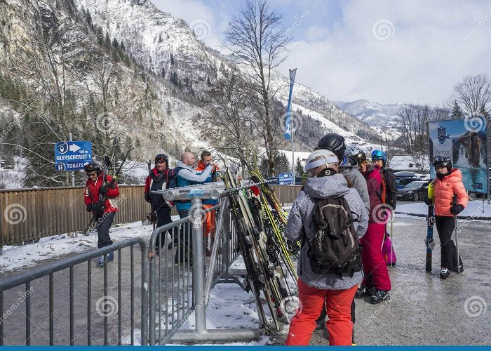 Gletscherjet I KAPRUN, AUSTRIA, March 12, 2019: People Skiers Going To Cable Car ... photo